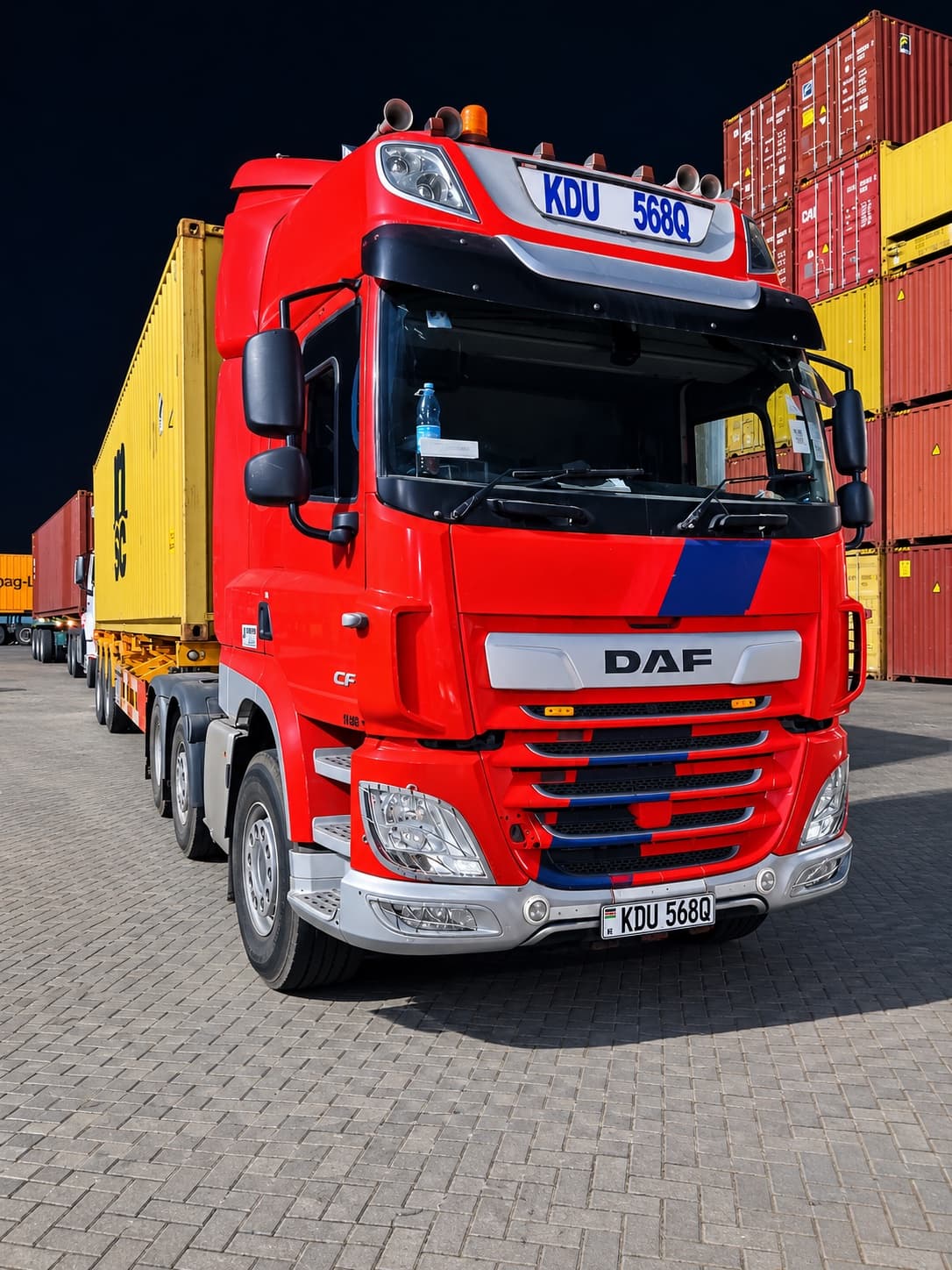 Mairem Transport red DAF tractor unit hauling a container at the port