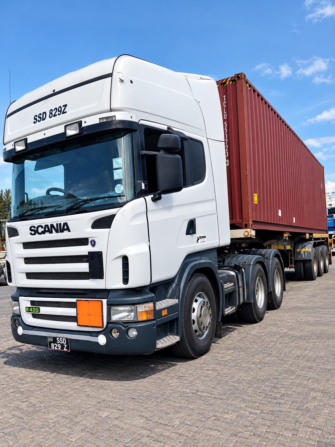 Mairem Transport white Scania tractor unit hauling a container at the port